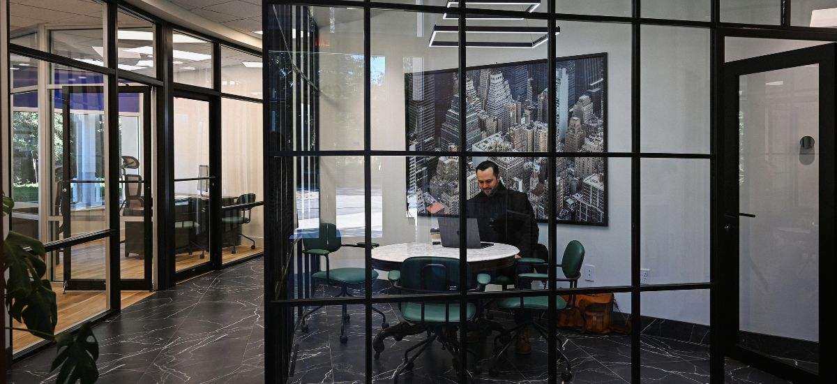 man alone in glass office