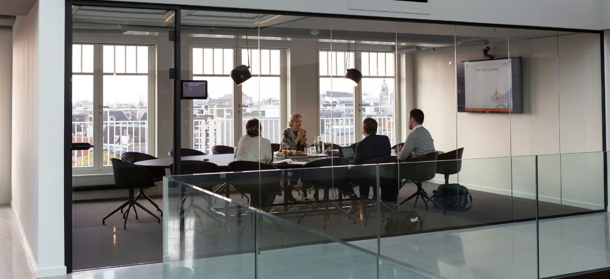 people-in-meeting-glass-wall