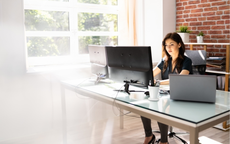 teacher working remotely on her computer